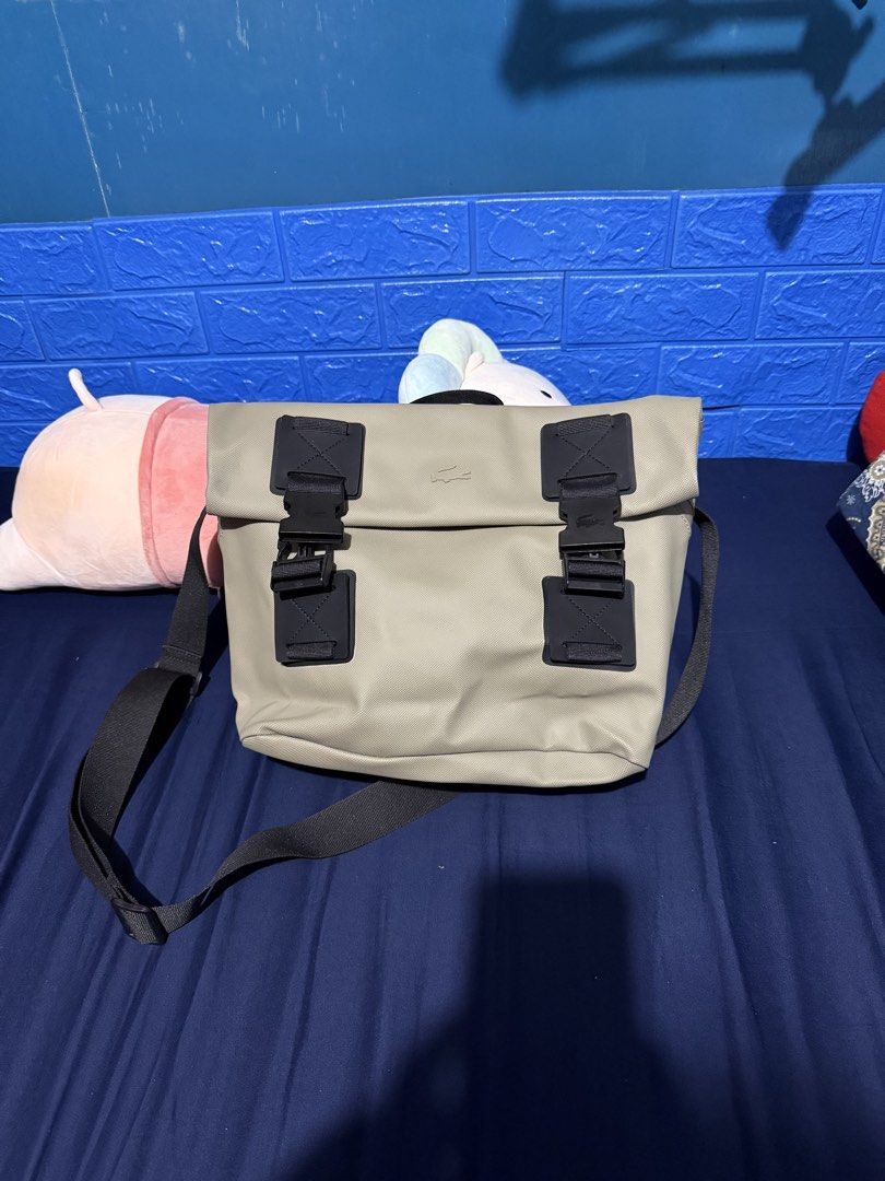 Lacoste Eco Kelp Messenger Bag (Category: Sling Bags) located in Paranaque City. Submitted by doc.k8 (Listing ID 1467159012, Image 1). Description: - Brand: Lacoste - Style: Messenger Bag / Daily Carry - Color: Olive Green with Black Strap - Material: 100% Durable Polyester Canvas - Closure: Dual buckle front flap - Interior: Dark grey lining with zippered pocket and Lacoste patch tag - Condition: Clean interior and exterior, excellent practical 