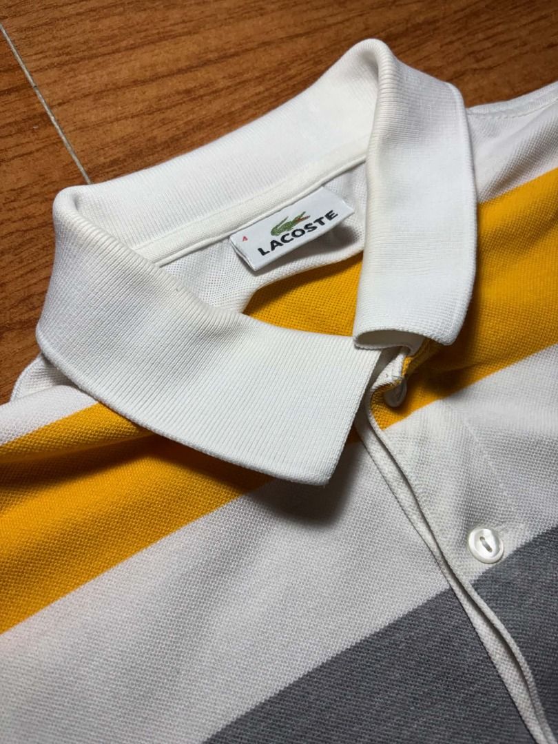 Lacoste Multi-Color Striped Polo Shirt (Category: Tshirts & Polo Shirts ) located in Marikina City. Submitted by maobuysstuff (Listing ID 1467012814, Image 3). Description: Lacoste Multi-Color Striped Polo Shirt - Style: Horizontal striped polo shirt (white, yellow, grey, light blue, rust orange) - Fits Small-Medium - 18" x 27" - Details: White ribbed collar, 3 mother-of-pearl buttons, iconic embroidered green crocodile logo - Flaw: Slight yellow