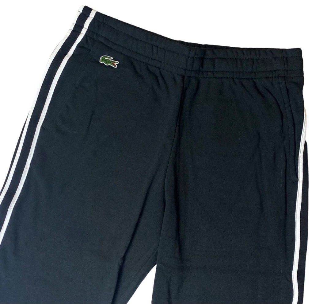 Lacoste Track Pants XH3286 Black Size L (Category: Joggers) located in Quezon City. Submitted by jutang21 (Listing ID 1467059604, Image 2). Description: - Brand: Lacoste - Item: Track Pants -Size 30 to 34W 37L - Color: Black with dual white side stripes - Logo: Embroidered green crocodile near the right pocket - Size: US L / FR 5 - Style Number: XH3286 - Waist: Elastic with drawstring - Condition: Clean inside and out, excellent pre-owned conditi
