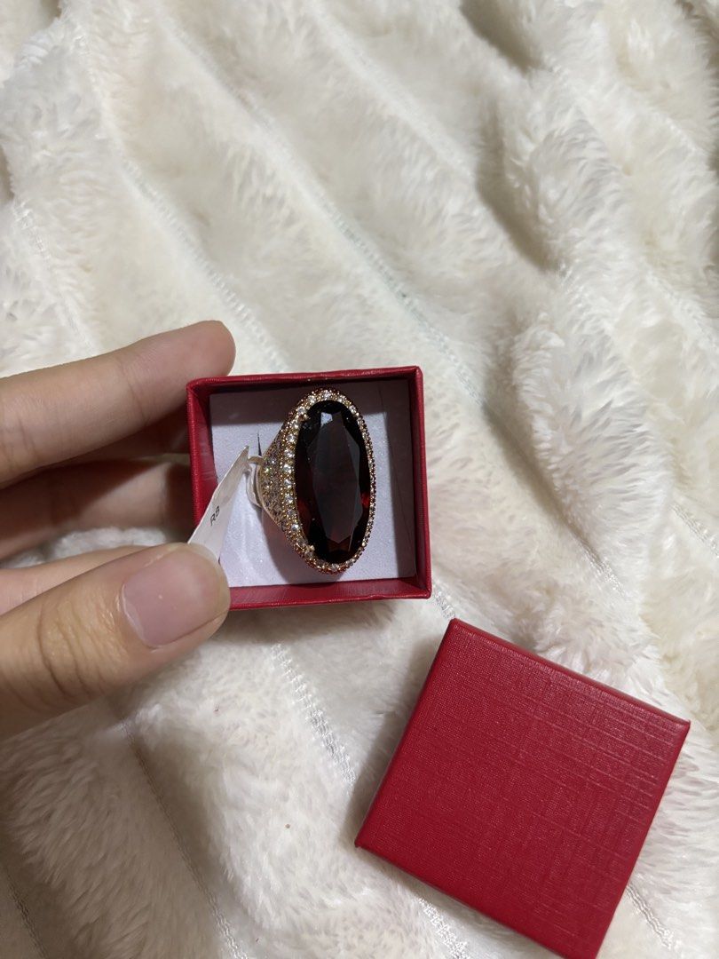 Large Oval Red Stone Ring with Pave Setting (Category: Rings) located in Quezon City. Submitted by hadescloset (Listing ID 1467062760, Image 1). Description: - Bold cocktail ring featuring a striking large red oval center stone - Rose gold band fully covered in sparkling pave stones - Eye-catching statement piece that catches the light beautifully - Comes in a stylish small red square box with a white insert.