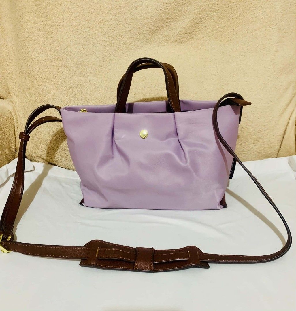 Legato Largo Bag (Category: Cross-body Bags) located in Dasmarinas. Submitted by pepperronnie (Listing ID 1464628195, Image 3). Description: A lavender multi-way tote/crossbody bag 💜 ✨ Details: - Color: Soft lilac / lavender purple with brown leather-like handles & strap ​ - Material: Lightweight, durable nylon body + gold hardware ​ - 2 ways to carry: handbag / tote OR use the detachable strap as crossbody/shoulder bag ​ - Simple, spacious & pe