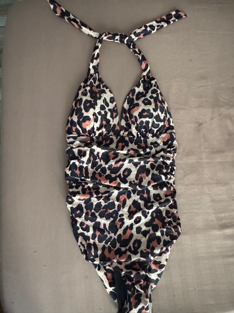 Leopard Print Halter Neck One Piece Swimsuit (Category: Bikinis & Swimsuits) located in Manila. Submitted by maliwana.gan (Listing ID 1467023549, Image 2). Description: Small on tag, can fit Medium Loc: Tomas Morato, QC - Trendy leopard print one-piece swimsuit in black, beige, and pink tones - Adjustable halter neck tie strap for a secure fit - Flattering ruched detailing down the front and sides - Ideal for beach trips, vacations, and pool part