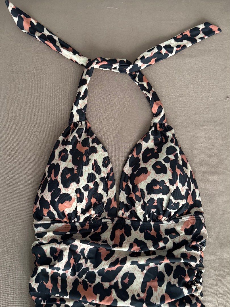 Leopard Print Halter Neck One Piece Swimsuit (Category: Bikinis & Swimsuits) located in Manila. Submitted by maliwana.gan (Listing ID 1467023549, Image 1). Description: Small on tag, can fit Medium Loc: Tomas Morato, QC - Trendy leopard print one-piece swimsuit in black, beige, and pink tones - Adjustable halter neck tie strap for a secure fit - Flattering ruched detailing down the front and sides - Ideal for beach trips, vacations, and pool part