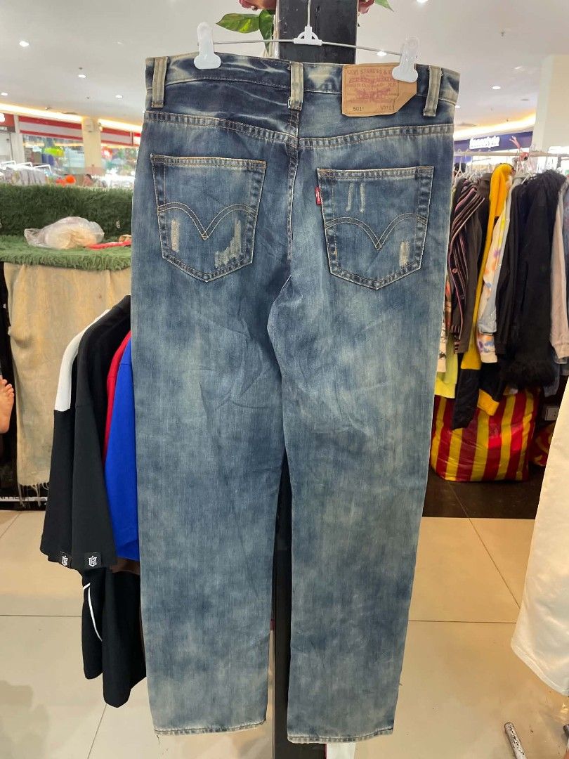 Levi's 501 Distressed Jeans W31 L32 (Category: Jeans) located in Cainta. Submitted by mariss.luxx (Listing ID 1467068356, Image 2). Description: - Brand: Levi's 501 - Color/Wash: Medium wash blue denim - Size: W31 L32 - Fit: Straight leg, comfortable standard fit - Details: Factory distressing, ripped front and back pockets, signature red tab - Closure: Classic button fly.