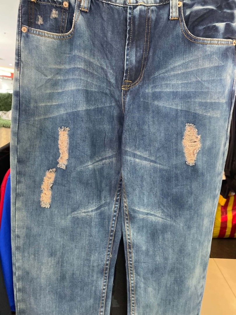 Levi's 501 Distressed Jeans W31 L32 (Category: Jeans) located in Cainta. Submitted by mariss.luxx (Listing ID 1467068356, Image 3). Description: - Brand: Levi's 501 - Color/Wash: Medium wash blue denim - Size: W31 L32 - Fit: Straight leg, comfortable standard fit - Details: Factory distressing, ripped front and back pockets, signature red tab - Closure: Classic button fly.