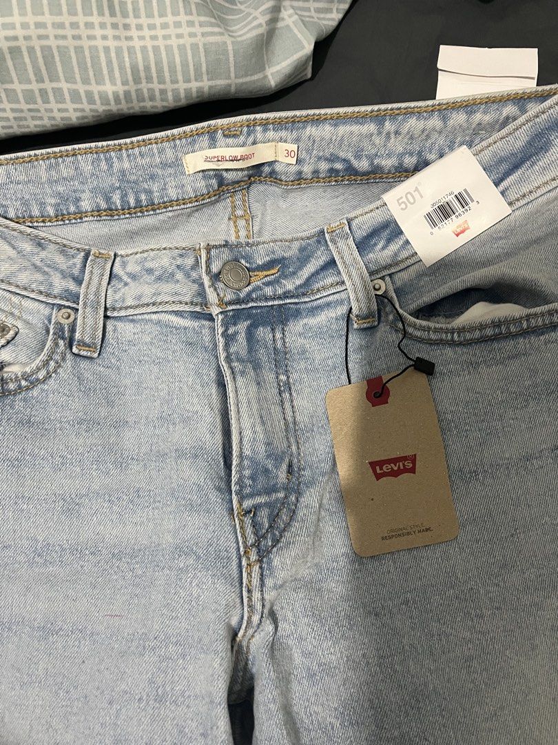 Levi's 501 Superlow Boot Light Wash Jeans Size 30 (Category: Jeans) located in Pasig City. Submitted by ecfcloset (Listing ID 1467027009, Image 2). Description: - Brand: Levi's 501 Superlow Boot - Size: 30 waist - Condition: Brand new with original paper tags attached - Material: 100% premium cotton - Color/Wash: Light wash denim - Features: Classic five-pocket styling, zip fly, metal button closure, and iconic back leather patch.