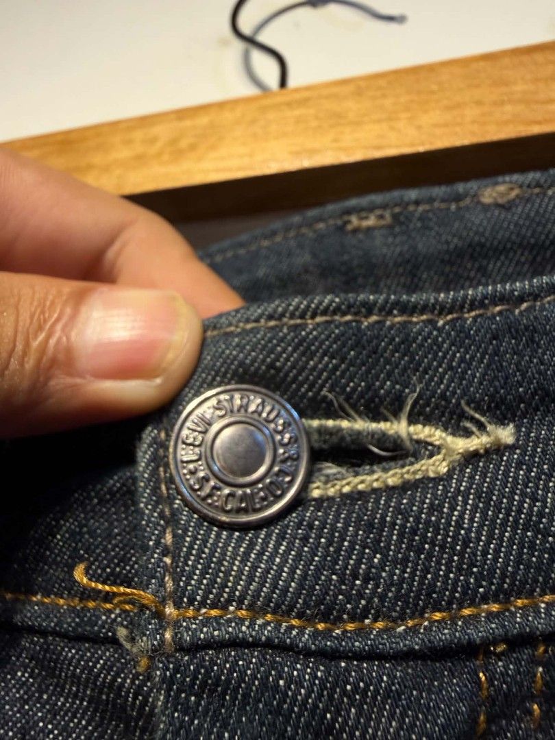 Levi's Dark Wash Denim Jeans (Category: Jeans) located in Carmen. Submitted by kyntmiras_thrift (Listing ID 1467116300, Image 3). Description: - Authentic Levi's dark wash denim jeans - Classic button fly closure with durable metal hardware - Timeless straight leg fit for everyday styling - Signature red tab logo on the back pocket - Genuine leather patch on the rear waistband - Contrast stitching detail throughout - Perfect wardrobe staple, read
