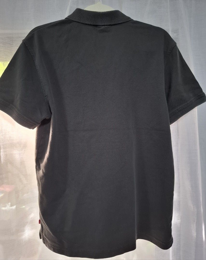 Levi's Gray Polo Shirt Size M (Category: Tshirts & Polo Shirts ) located in Manila. Submitted by jazil.ladyliz (Listing ID 1467044071, Image 3). Description: - Brand: Levi's - Color: Dark Grey / Black - Size: Medium (M) - Material: Premium Cotton Pique - Design: Classic collar, single button placket, short sleeves - Branding: Embroidered red Levi's logo on left chest - Measurements: ~20inches pit-to-pit, ~25 inches length - Condition: Excellent, 