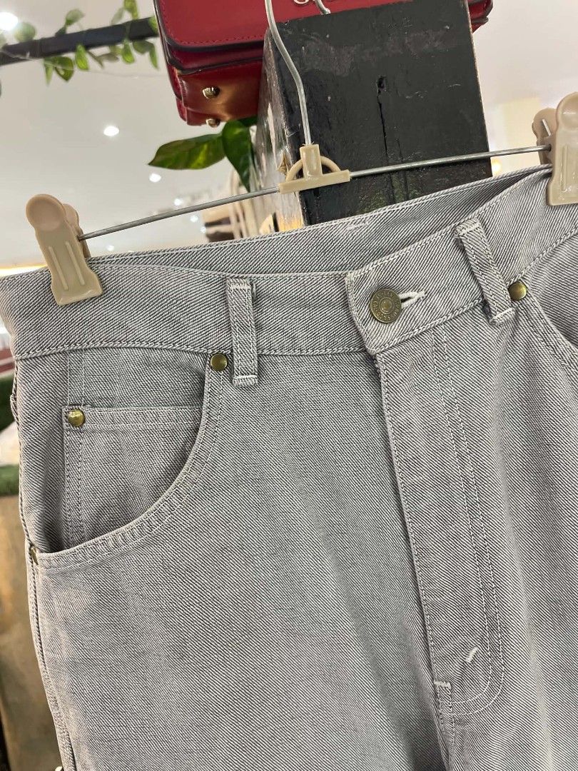 Levi's Grey Jeans Straight Fit Size 30 (Category: Jeans) located in Cainta. Submitted by riszizlux (Listing ID 1467068978, Image 3). Description: - Brand: Levi's - Color: Versatile grey with a subtle twill pattern - Fit: Classic straight leg cut - Closure: Button fly - Pockets: Front pockets and two rear pockets - Details: Branded leather patch and signature red tab on the back - Condition: Hem shows slight natural fraying from wear.