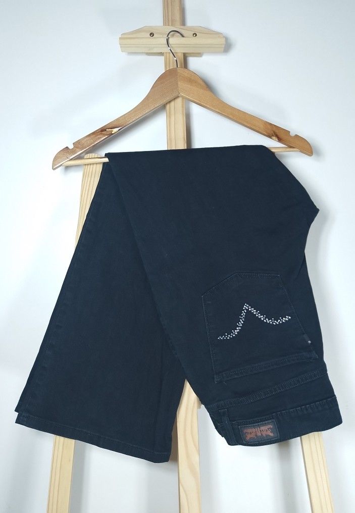 Levi's Perfectly Slimming Boot Jeans Black Size 17 (Category: Jeans) located in Manila. Submitted by patrickjos06722 (Listing ID 1467140235, Image 1). Description: - Brand: Levi's - Style: Black bootcut jeans with rhinestone embellishments on back pockets - Rise: Mid-rise fit with classic button and zip fly - Black tab - Size: Waist measures roughly 32 to 34 inches across laying flat - Top to bottom measurement is 39 inches - Condition: Clean fab