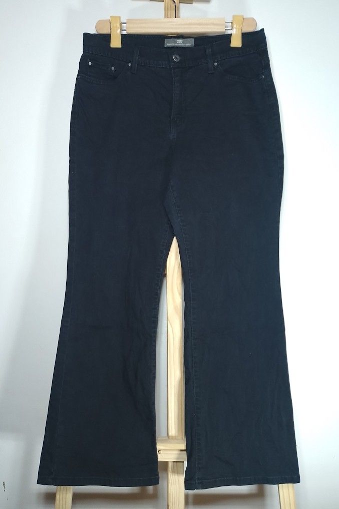 Levi's Perfectly Slimming Boot Jeans Black Size 17 (Category: Jeans) located in Manila. Submitted by patrickjos06722 (Listing ID 1467140235, Image 2). Description: - Brand: Levi's - Style: Black bootcut jeans with rhinestone embellishments on back pockets - Rise: Mid-rise fit with classic button and zip fly - Black tab - Size: Waist measures roughly 32 to 34 inches across laying flat - Top to bottom measurement is 39 inches - Condition: Clean fab