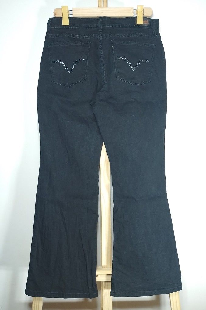 Levi's Perfectly Slimming Boot Jeans Black Size 17 (Category: Jeans) located in Manila. Submitted by patrickjos06722 (Listing ID 1467140235, Image 3). Description: - Brand: Levi's - Style: Black bootcut jeans with rhinestone embellishments on back pockets - Rise: Mid-rise fit with classic button and zip fly - Black tab - Size: Waist measures roughly 32 to 34 inches across laying flat - Top to bottom measurement is 39 inches - Condition: Clean fab