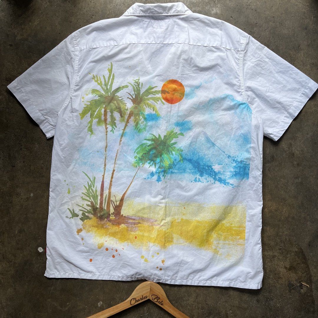 Levi's Relaxed Fit Shirt (Category: Tshirts & Polo Shirts ) located in Davao. Submitted by charlesole52665 (Listing ID 1467140236, Image 2). Description: - Brand: Levi's - Style: Relaxed fit short-sleeve button-up shirt - Size: Large - Color: White with watercolor palm tree & mountain print - Details: Small "Waking Rest" chest graphic, standard collar, front button closure - Condition: Excellent / Pre-loved (ready to wear).