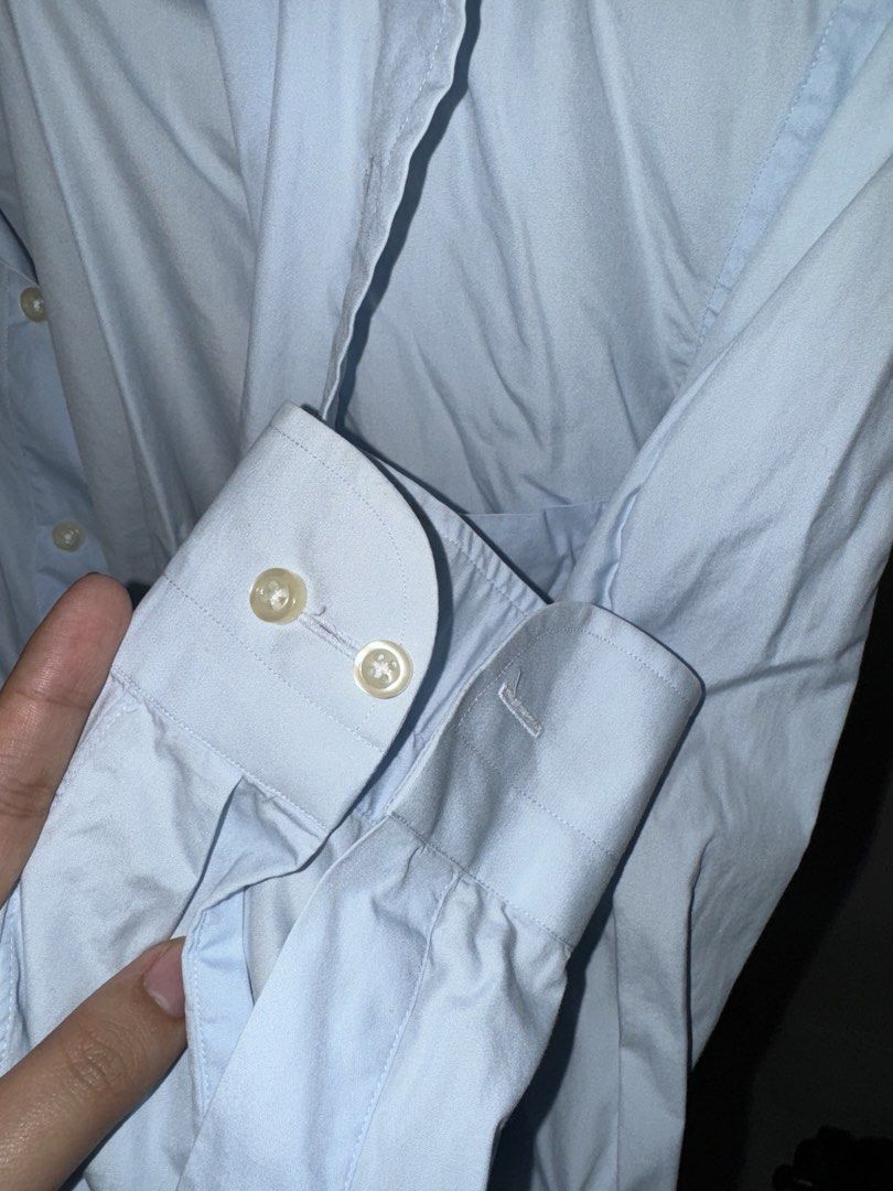 Light Blue Long Sleeve Button-Up Shirt (Category: Tshirts & Polo Shirts ) located in La Trinidad. Submitted by prelovedandfindsbyji (Listing ID 1466978608, Image 3). Description: - Color: Light blue - Style: Long sleeve button-up with standard collar and chest pocket - Details: Buttoned cuffs, classic wardrobe basic - Best for: Work or casual outings - Condition: Natural wrinkling from storage, needs an iron.