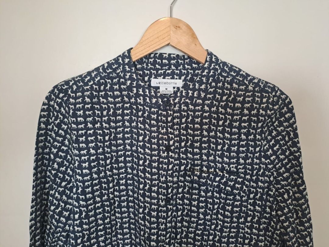 Liz Claiborne horse print (Category: Longsleeves) located in Mandaluyong City. Submitted by epicowl-c93c (Listing ID 1467095106, Image 2). Description: This Liz Claiborne button-front blouse features a charming, dense navy and white novelty animal pattern. Crafted from a fluid, lightweight fabric—typically made from soft lyocell or a comfortable rayon blend—it features long sleeves, a clean band collar, and a convenient left chest pocket..
