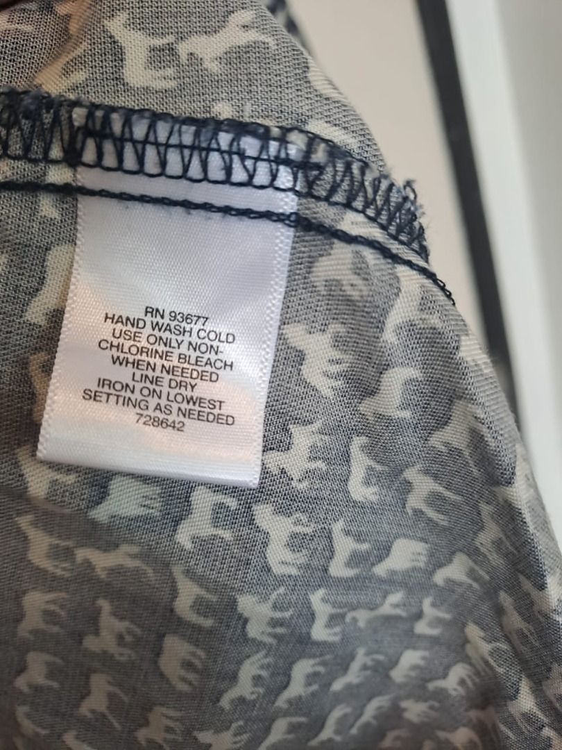 Liz Claiborne horse print (Category: Longsleeves) located in Mandaluyong City. Submitted by epicowl-c93c (Listing ID 1467095106, Image 3). Description: This Liz Claiborne button-front blouse features a charming, dense navy and white novelty animal pattern. Crafted from a fluid, lightweight fabric—typically made from soft lyocell or a comfortable rayon blend—it features long sleeves, a clean band collar, and a convenient left chest pocket..
