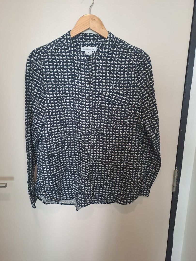 Liz Claiborne horse print (Category: Longsleeves) located in Mandaluyong City. Submitted by epicowl-c93c (Listing ID 1467095106, Image 1). Description: This Liz Claiborne button-front blouse features a charming, dense navy and white novelty animal pattern. Crafted from a fluid, lightweight fabric—typically made from soft lyocell or a comfortable rayon blend—it features long sleeves, a clean band collar, and a convenient left chest pocket..