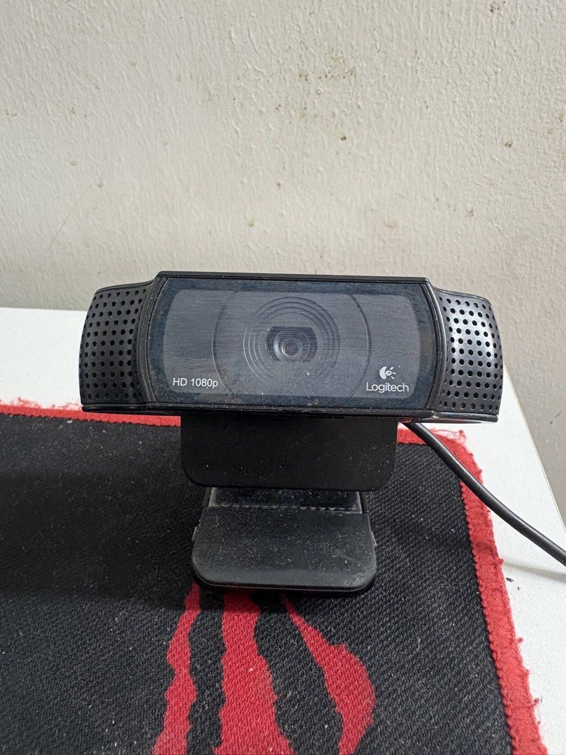 Logitech HD 1080p Webcam (Category: Webcams) located in Quezon City. Submitted by sellerofused (Listing ID 1466988923, Image 2). Description: - Brand: Logitech Webcam - Resolution: HD 1080p for clear video calls - Color/Design: Black finish with stylish side speaker grilles - Stand: Adjustable monitor mount included for easy setup - Connectivity: Attached USB cable ready to plug and play - Condition: Dusty from sitting on the desk, but fully work