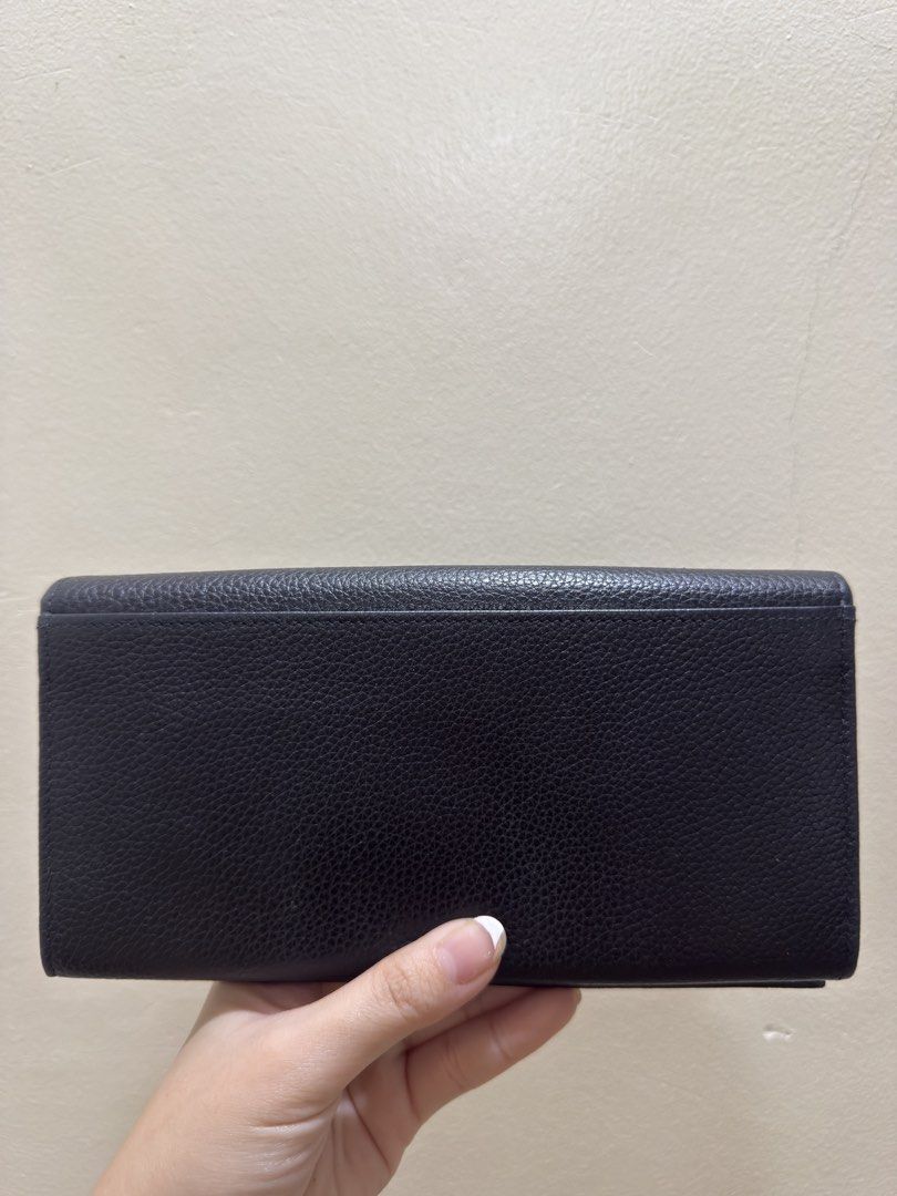 Longchamp Black Leather Long Wallet (Category: Luxury Bags & Wallets) located in Quezon City. Submitted by cndcvrtc (Listing ID 1467154782, Image 3). Description: - Brand: Longchamp - Material: Premium black grained leather with a pebble-textured finish - Closure: Secure snap button closure on both sides - Storage: Multiple card slots and spacious bill compartments - Coin Pocket: Convenient interior zippered coin pocket - Condition: Clean interio