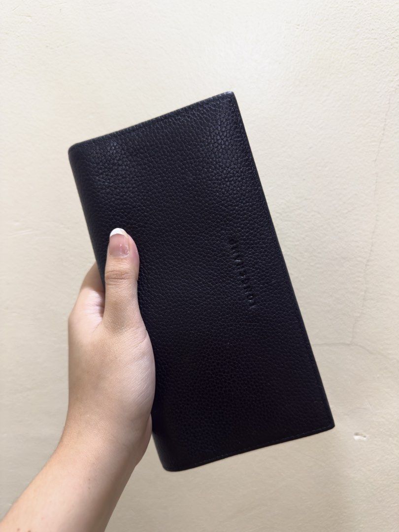 Longchamp Black Leather Long Wallet (Category: Luxury Bags & Wallets) located in Quezon City. Submitted by cndcvrtc (Listing ID 1467154782, Image 1). Description: - Brand: Longchamp - Material: Premium black grained leather with a pebble-textured finish - Closure: Secure snap button closure on both sides - Storage: Multiple card slots and spacious bill compartments - Coin Pocket: Convenient interior zippered coin pocket - Condition: Clean interio