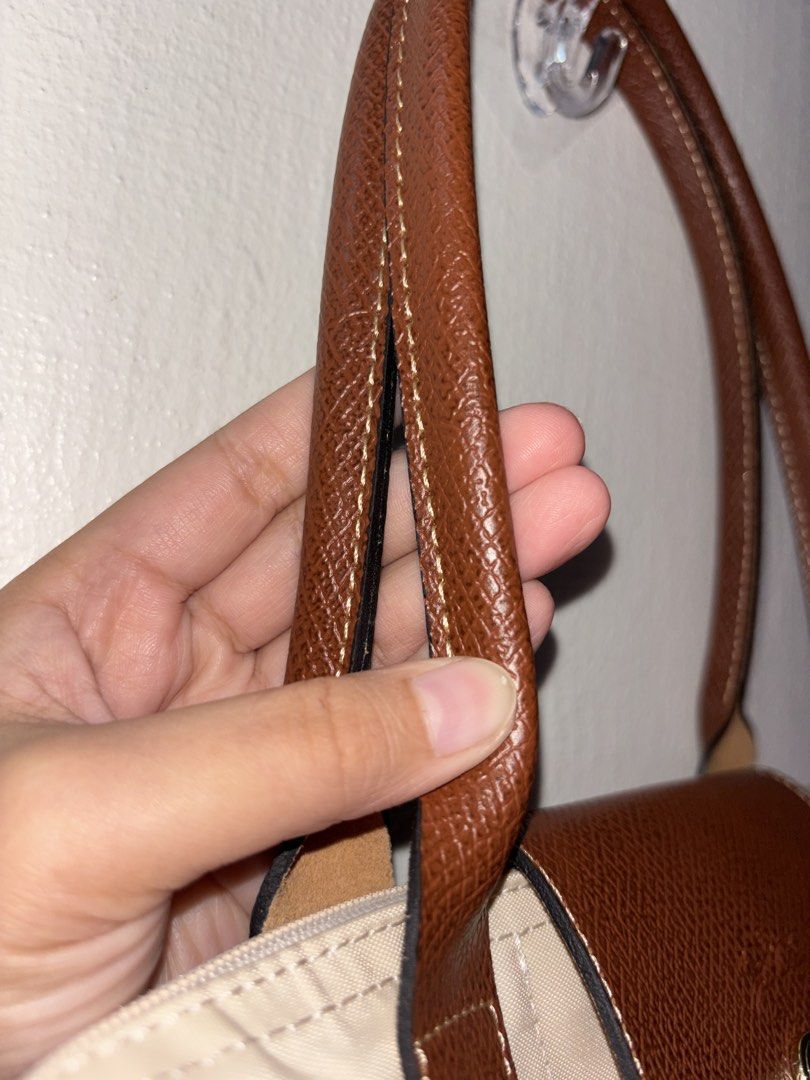 Longchamp Le Pliage Beige Tote Bag (Category: Luxury Bags & Wallets) located in Tarlac. Submitted by chosowakatoshi (Listing ID 1467095810, Image 3). Description: -Longchamp tote bag - Elegant beige nylon body with structured brown leather trim - Secure front flap with snap button closure - Classic gold-tone hardware details - Clean leather handles with nice contrast stitching - Spacious and perfect for daily use or travel - RUSH SALE / PM for in