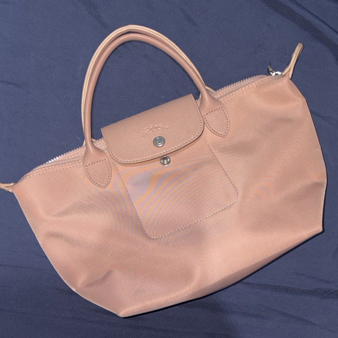 Longchamp Le Pliage Short Handle Tote Bag Pink (Category: Luxury Bags & Wallets) located in Manila. Submitted by mixofsunshine_ (Listing ID 1467017797, Image 2). Description: - Brand: Longchamp Le Pliage - Color: Dusty Pink - Material: Lightweight nylon body with matching leather trim - Closure: Zip top with front flap and snap button - Handles: Short top handles - Condition: Clean fabric and structured shape overall - Style: Classic foldable des