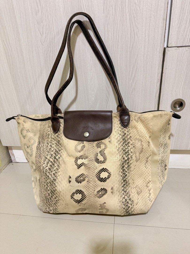 Longchamp Tote Bag Python Snake Print Leather (Category: Luxury Bags & Wallets) located in Manila. Submitted by rrtolibas48132 (Listing ID 1467065501, Image 1). Description: - Brand: Longchamp - Design: Python snake print canvas with brown leather handles and flap - Hardware: Silver-tone with PRYM snap button - Closure: Secure zip top - Interior: Includes a handy zippered compartment - Straps: Comfortable double leather straps for shoulder carry 