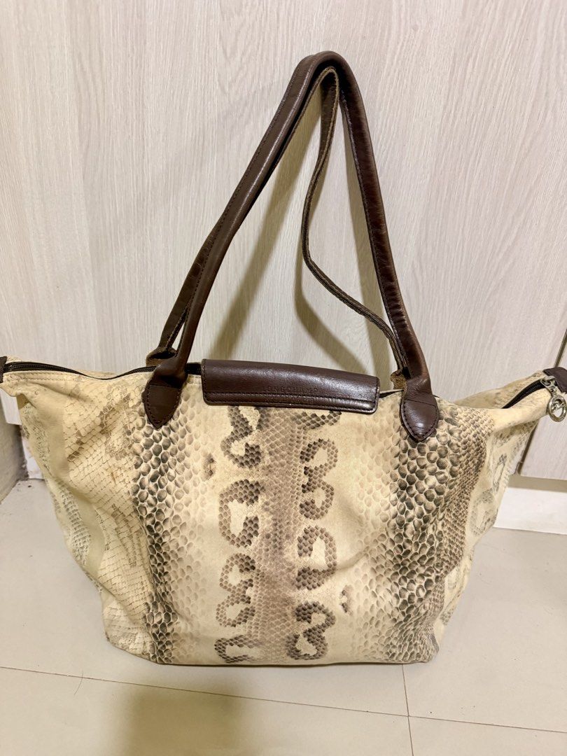 Longchamp Tote Bag Python Snake Print Leather (Category: Luxury Bags & Wallets) located in Manila. Submitted by rrtolibas48132 (Listing ID 1467065501, Image 2). Description: - Brand: Longchamp - Design: Python snake print canvas with brown leather handles and flap - Hardware: Silver-tone with PRYM snap button - Closure: Secure zip top - Interior: Includes a handy zippered compartment - Straps: Comfortable double leather straps for shoulder carry 