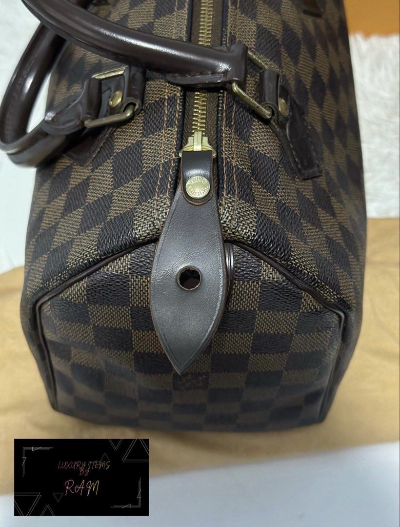 Louis Vuitton Damier Ebene Speedy Handbag (Category: Luxury Bags & Wallets) located in Manila. Submitted by rhea.1215 (Listing ID 1467167094, Image 3). Description: - Brand: Louis Vuitton - Model: Speedy Handbag - Material: Damier Ebene canvas with dark brown leather trim - Hardware: Gold-tone with engraved zipper pull - Features: Double rolled leather top handles, secure zip closure, and iconic LV Paris stamped front tab - Condition: Excellent, 