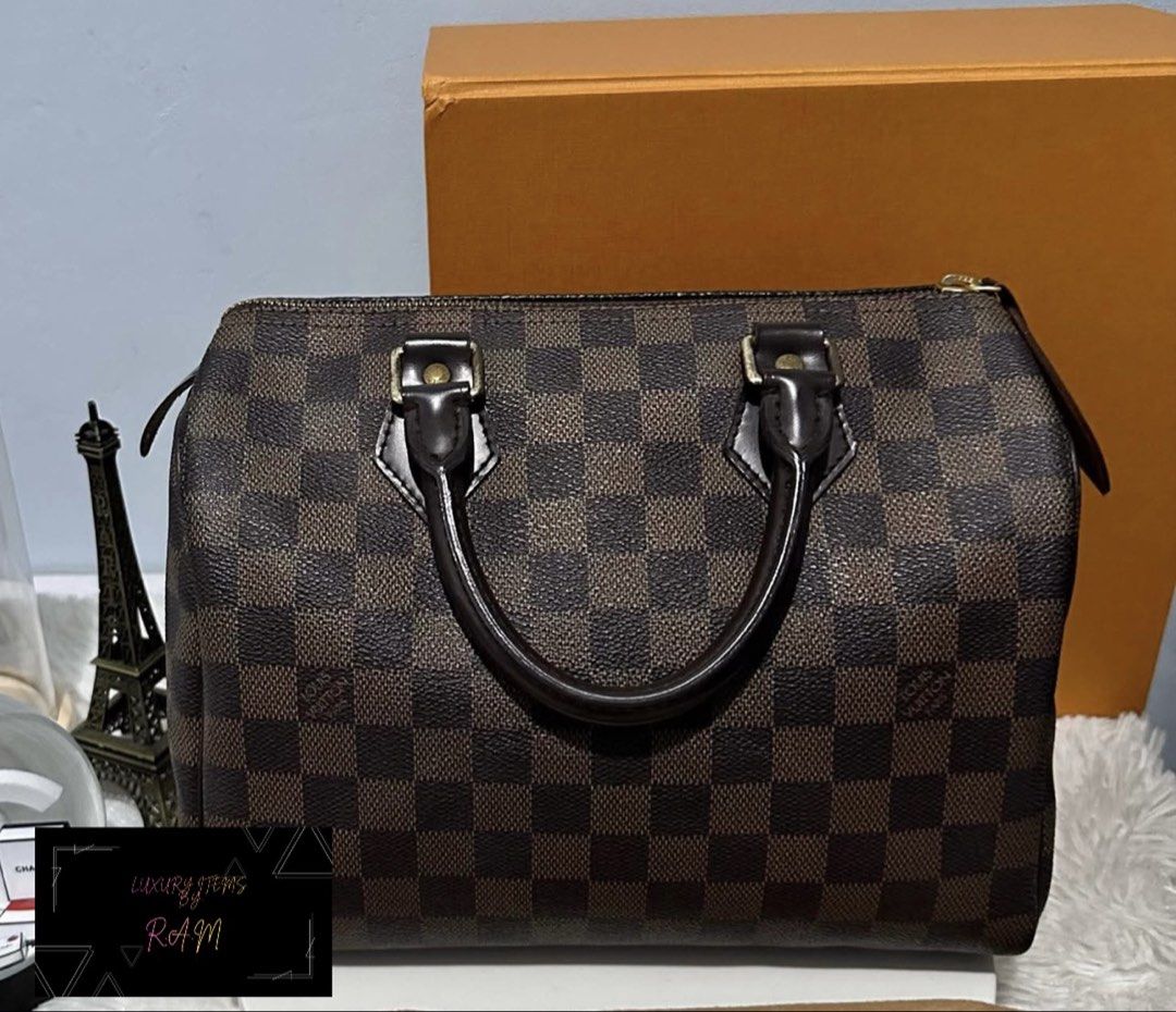 Louis Vuitton Damier Ebene Speedy Handbag (Category: Luxury Bags & Wallets) located in Manila. Submitted by rhea.1215 (Listing ID 1467167094, Image 2). Description: - Brand: Louis Vuitton - Model: Speedy Handbag - Material: Damier Ebene canvas with dark brown leather trim - Hardware: Gold-tone with engraved zipper pull - Features: Double rolled leather top handles, secure zip closure, and iconic LV Paris stamped front tab - Condition: Excellent, 