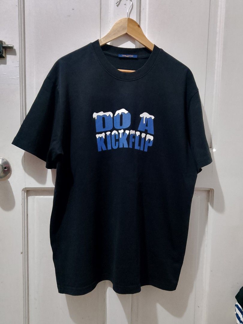 Louis Vuitton Do A Kickflip T-Shirt Black (Category: Tshirts & Polo Shirts ) located in Caloocan City. Submitted by wirlynbina94604 (Listing ID 1467127633, Image 1). Description: - Brand: Louis Vuitton - Color: Black with blue accents - Design: 'DO A KICKFLIP' snowy front text and large blue snow-detailed LV logo on the back - Cut: Crew neckline, short sleeves - Details: Blue collar tag with gold branding and CA 36929 code - Condition: Excellent 