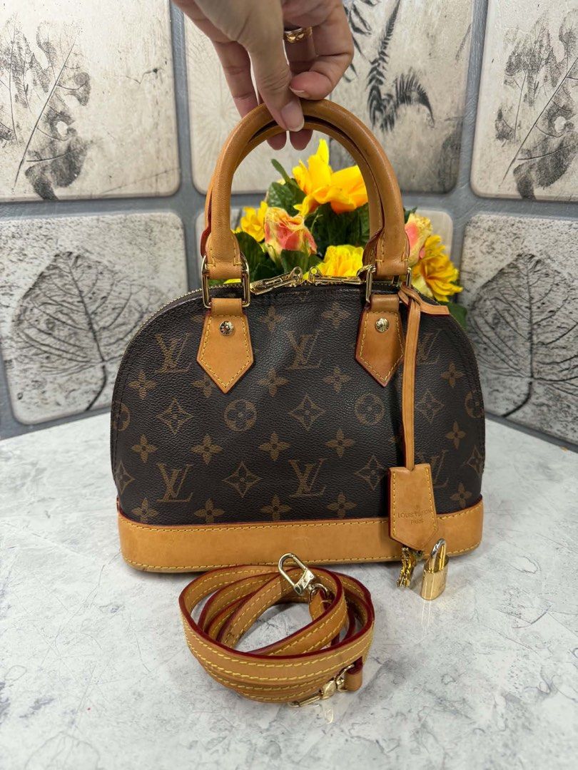 Louis Vuitton Monogram Alma BB Handbag (Category: Luxury Bags & Wallets) located in Angono. Submitted by xxxallaboutbagsxxx (Listing ID 1467129549, Image 1). Description: - Authentic Louis Vuitton Monogram canvas handbag with classic structured shape - Beautiful natural cowhide leather trim with a light honey patina - Dual rolled top handles and a convenient detachable shoulder strap - Secure double zip closure with gold-tone hardware throughout 