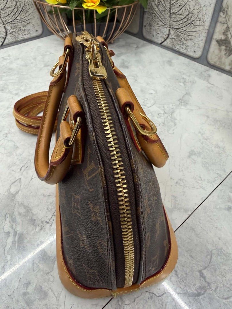 Louis Vuitton Monogram Alma BB Handbag (Category: Luxury Bags & Wallets) located in Angono. Submitted by xxxallaboutbagsxxx (Listing ID 1467129549, Image 2). Description: - Authentic Louis Vuitton Monogram canvas handbag with classic structured shape - Beautiful natural cowhide leather trim with a light honey patina - Dual rolled top handles and a convenient detachable shoulder strap - Secure double zip closure with gold-tone hardware throughout 