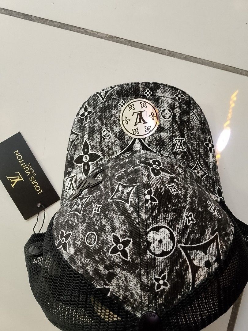 Louis Vuitton Monogram Black And White Mesh Trucker Cap (Category: Caps & Hats) located in Quezon City. Submitted by viaggo.travels (Listing ID 1467039133, Image 3). Description: - Iconic black and white L V monogram print - Breathable mesh back panels for all-day comfort - Adjustable leather strap with embossed branding for a custom fit - Circular metallic L V logo on the front brim and dark L. V side emblem - Brand new with hang tag attached.