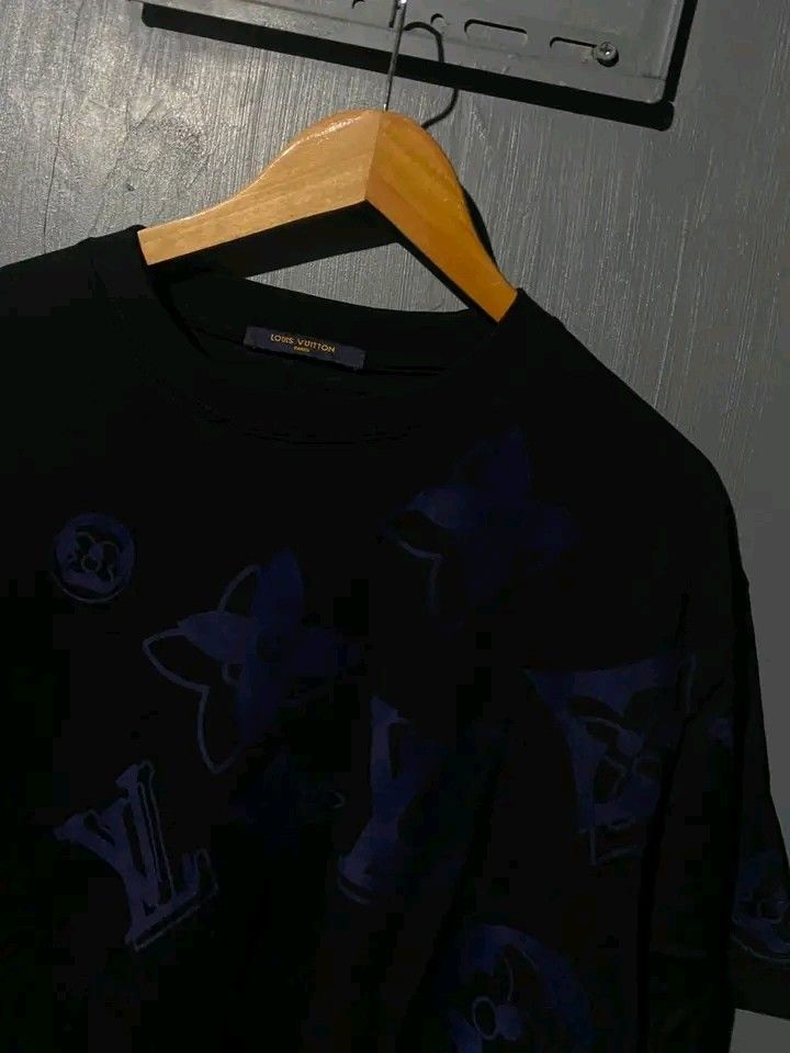 Louis Vuitton Monogram Blue Black T-Shirt (Category: Tshirts & Polo Shirts ) located in Manila. Submitted by bright.mayess (Listing ID 1467059382, Image 3). Description: - Brand: Louis Vuitton Paris - Color: Black with blue monogram print - Style: Short sleeves, crew neck - Details: Interior tag includes CA 36929 and Louis Vuitton Japan K.K. info - Condition: Clean fabric, excellent graphic placement - Ideal for casual luxury wear.