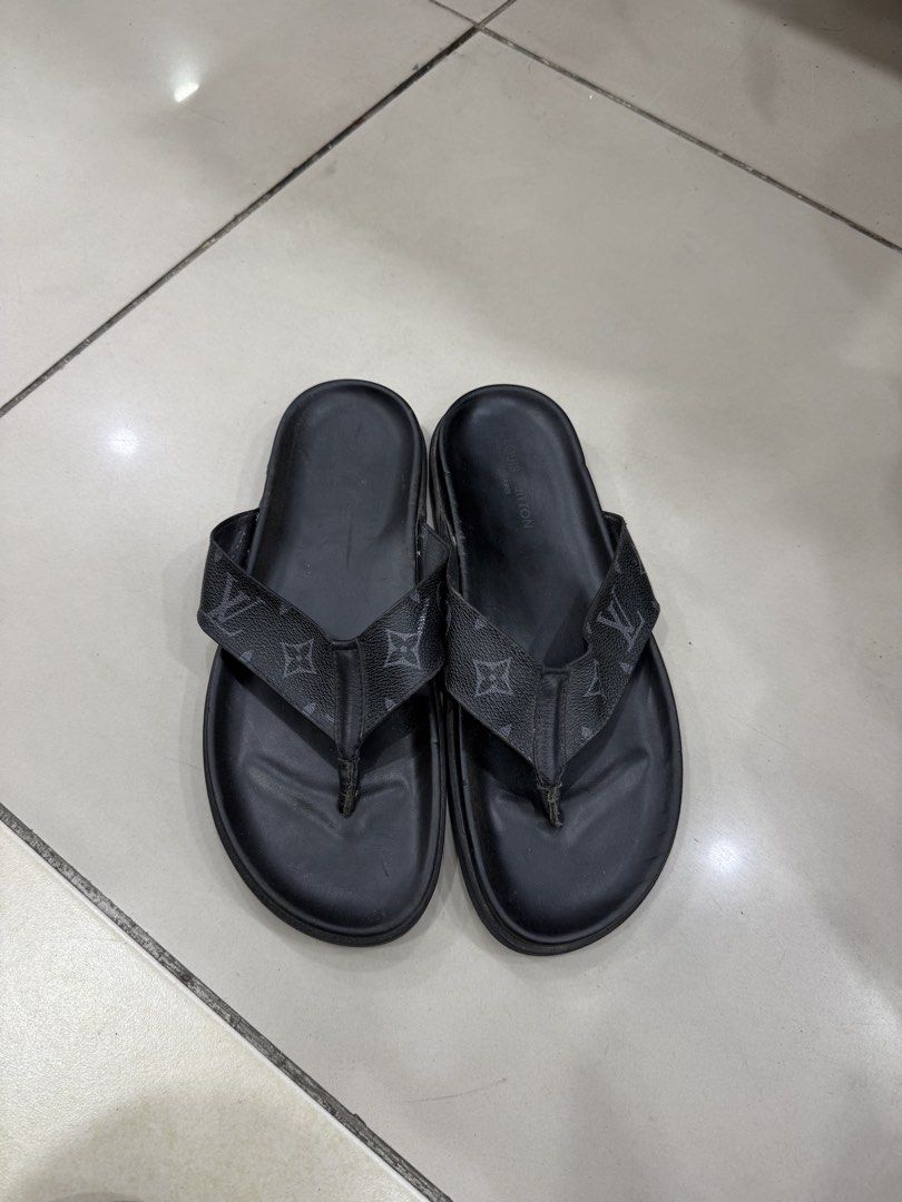 Louis Vuitton Monogram Flip Flops Size 42 (Category: Sneakers & Footwear) located in Bacolod City. Submitted by kitcarsonduff (Listing ID 1466995304, Image 1). Description: - Brand: Louis Vuitton - Style: Casual slip-on flip flops - Color: Black with iconic monogram strap design - Size: 42 (indicated on inner strap) - Soles: Rubber ribbed outsoles with LV branding for grip - Condition: Normal signs of use on soles and footbeds, still very wearabl
