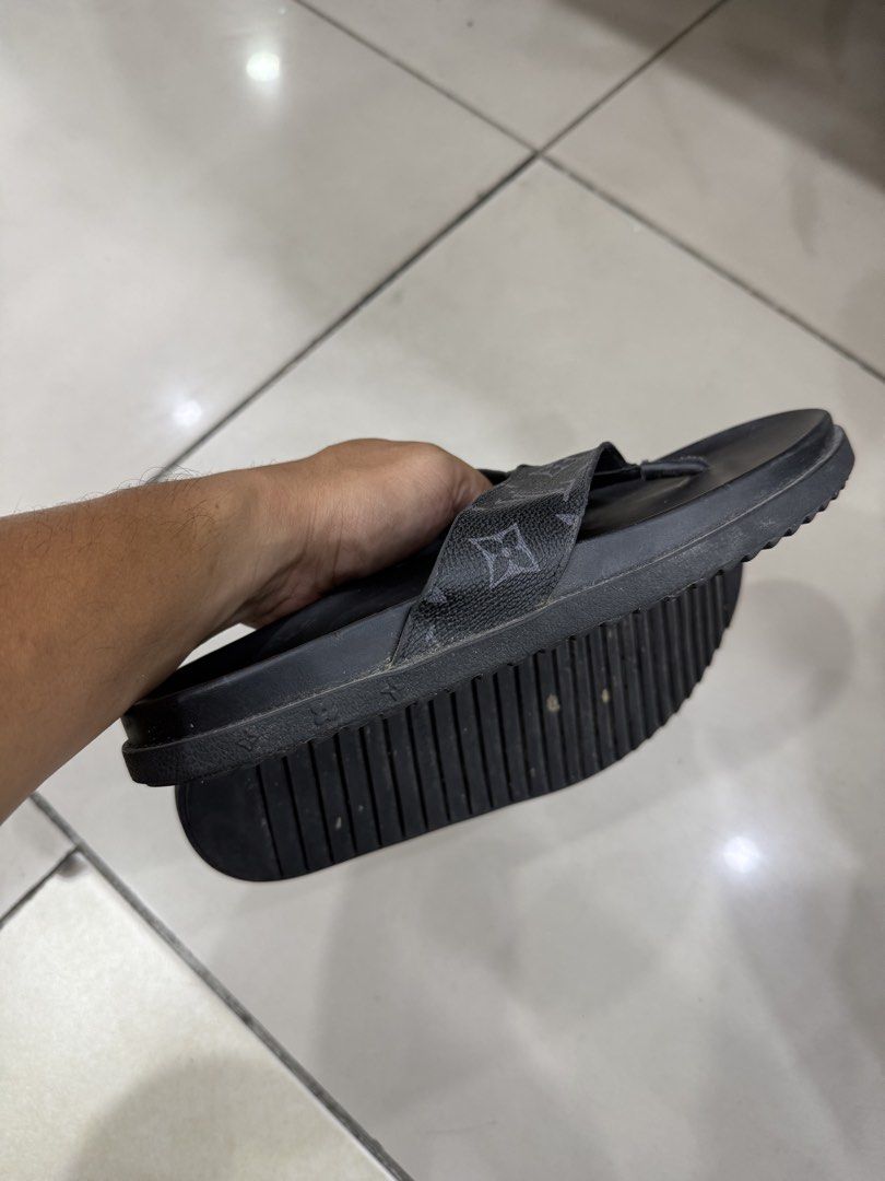 Louis Vuitton Monogram Flip Flops Size 42 (Category: Sneakers & Footwear) located in Bacolod City. Submitted by kitcarsonduff (Listing ID 1466995304, Image 2). Description: - Brand: Louis Vuitton - Style: Casual slip-on flip flops - Color: Black with iconic monogram strap design - Size: 42 (indicated on inner strap) - Soles: Rubber ribbed outsoles with LV branding for grip - Condition: Normal signs of use on soles and footbeds, still very wearabl