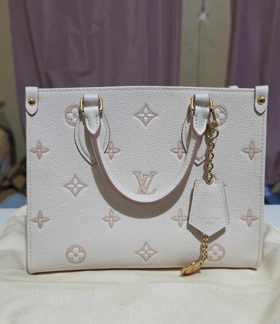 Louis Vuitton OTG Monogram Empreinte Leather (Category: Luxury Bags & Wallets) located in Manila. Submitted by a.sta.ana13 (Listing ID 1467042476, Image 1). Description: The funds raise here will go straight to my aunt’s medical expenses - Material: White grained leather with pink Monogram print - Hardware: Gold-tone hardware with matching front charm chain - Design: Structured rectangular shape with reinforced corners and rolled leather top hand