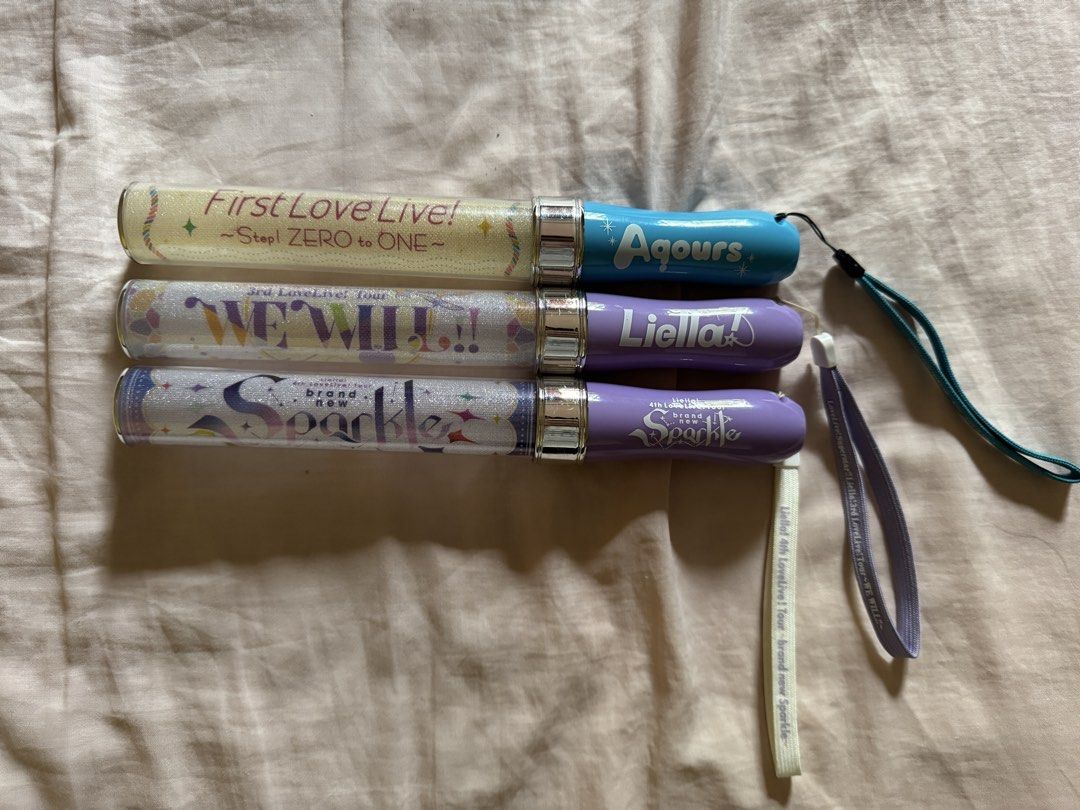Love Live! Penlights (Category: J-Wave Merchandise) located in Cebu City. Submitted by vincevins27 (Listing ID 1467036930, Image 1). Description: Love Live! series penlights for sale. Consists of the following: - Aqours First LoveLive! ~Step! ZERO to ONE~ (Blue handle) - 750 php Condition: lightly used, discolored due to being in the storage for a long time - Liella! 3rd LoveLive! Tour WE WILL!! (Purple handle) - 1,500 php Condition: lightly used