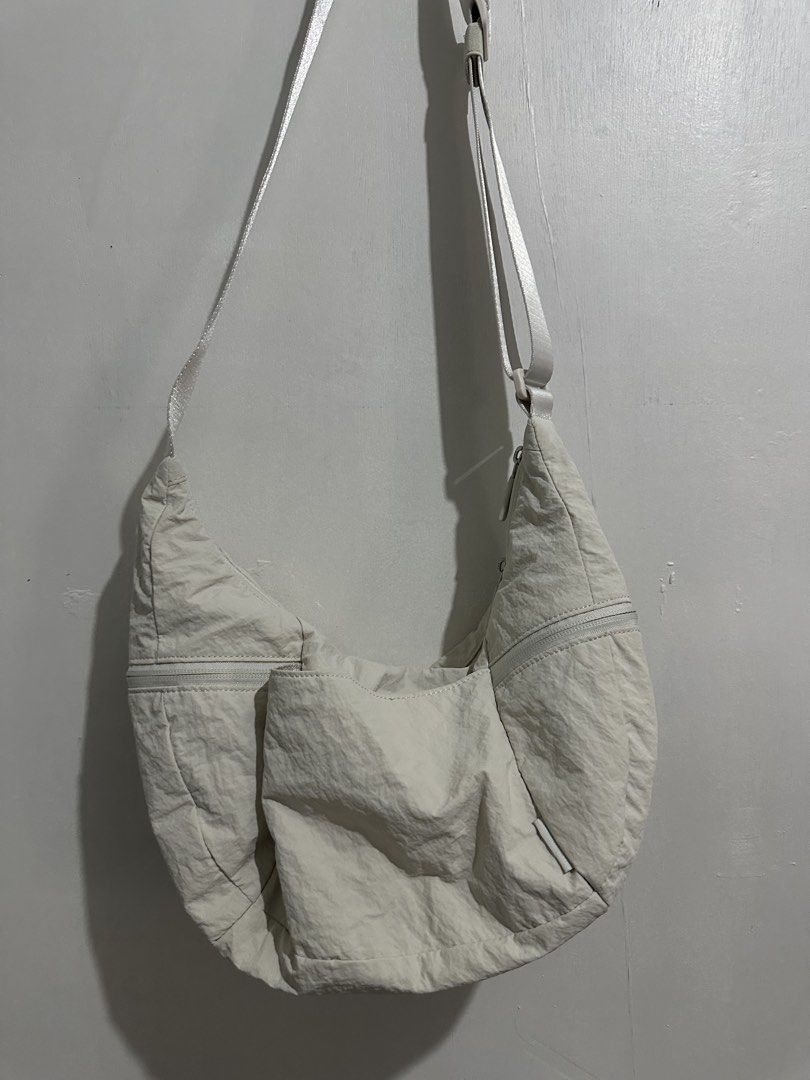 Lululemon Multi-Pocket Nylon Shoulder Bag Off White (Category: Shoulder Bags) located in Digos. Submitted by ken18_hawk (Listing ID 1466977231, Image 1). Description: - Brand: Lululemon - Color: Off-white - Material: Durable nylon - Strap: Adjustable with buckle hardware - Pockets: Multiple exterior zip/slip pockets & interior mesh zippered compartments with slip pockets - Closure: Zip top with branded zipper pulls - Details: Includes signature L