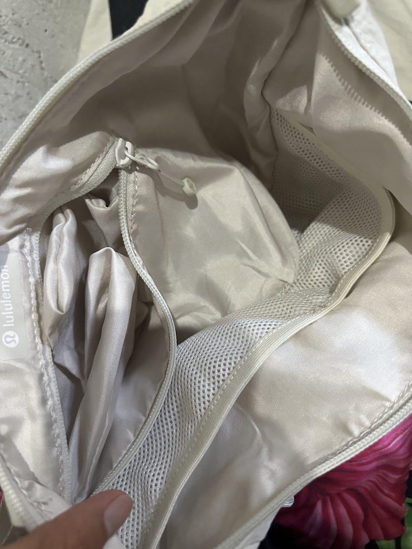 Lululemon Multi-Pocket Nylon Shoulder Bag Off White (Category: Shoulder Bags) located in Digos. Submitted by ken18_hawk (Listing ID 1466977231, Image 2). Description: - Brand: Lululemon - Color: Off-white - Material: Durable nylon - Strap: Adjustable with buckle hardware - Pockets: Multiple exterior zip/slip pockets & interior mesh zippered compartments with slip pockets - Closure: Zip top with branded zipper pulls - Details: Includes signature L