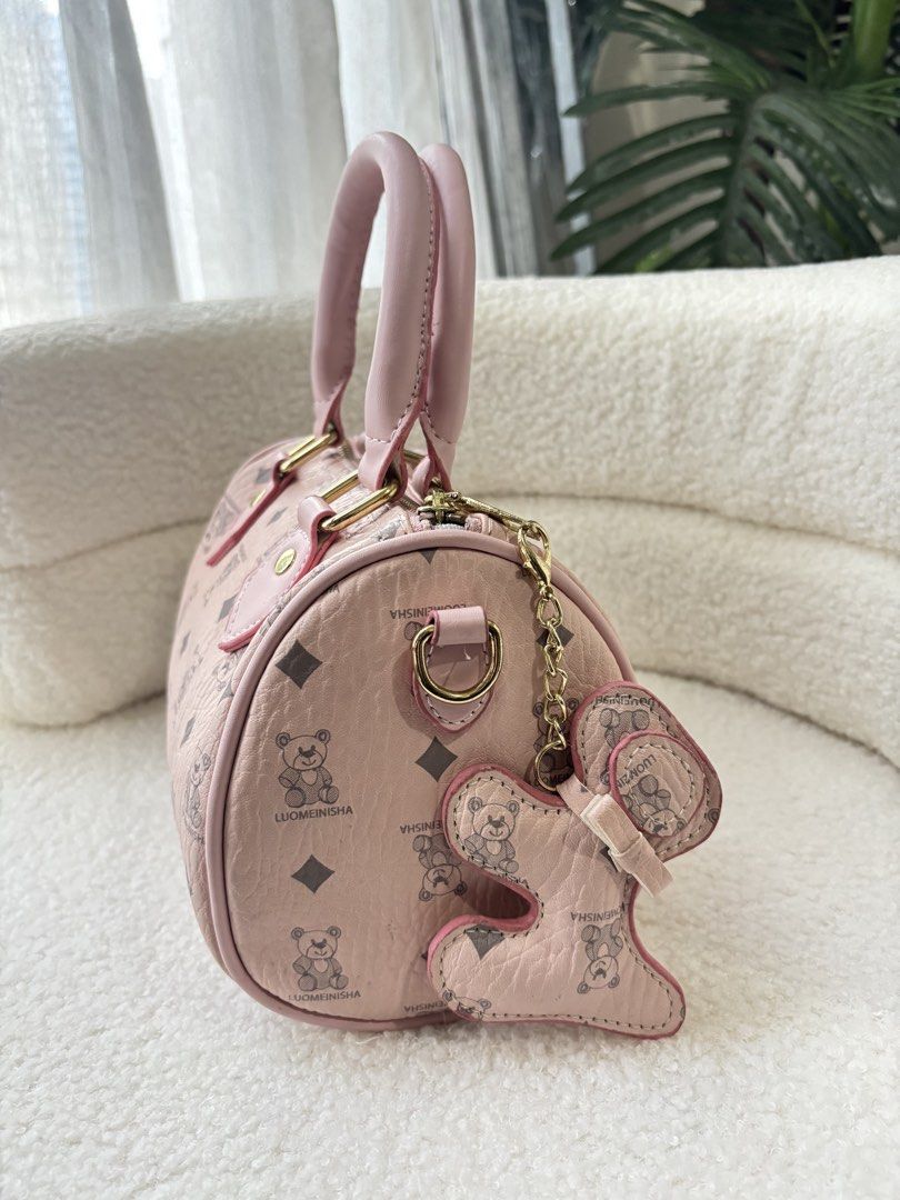 LUOMEINISHA Pink Bear Pattern Mini Barrel Handbag (Category: Shoulder Bags) located in Makati City. Submitted by bittersweet818ta (Listing ID 1467137996, Image 3). Description: - Adorable pink barrel handbag with teddy bear and diamond monogram pattern - Dual pink faux leather top handles and secure top zip closure - Includes a cute matching shaped bag charm with gold-toned hardware - Versatile design featuring a removable/detachable strap inside