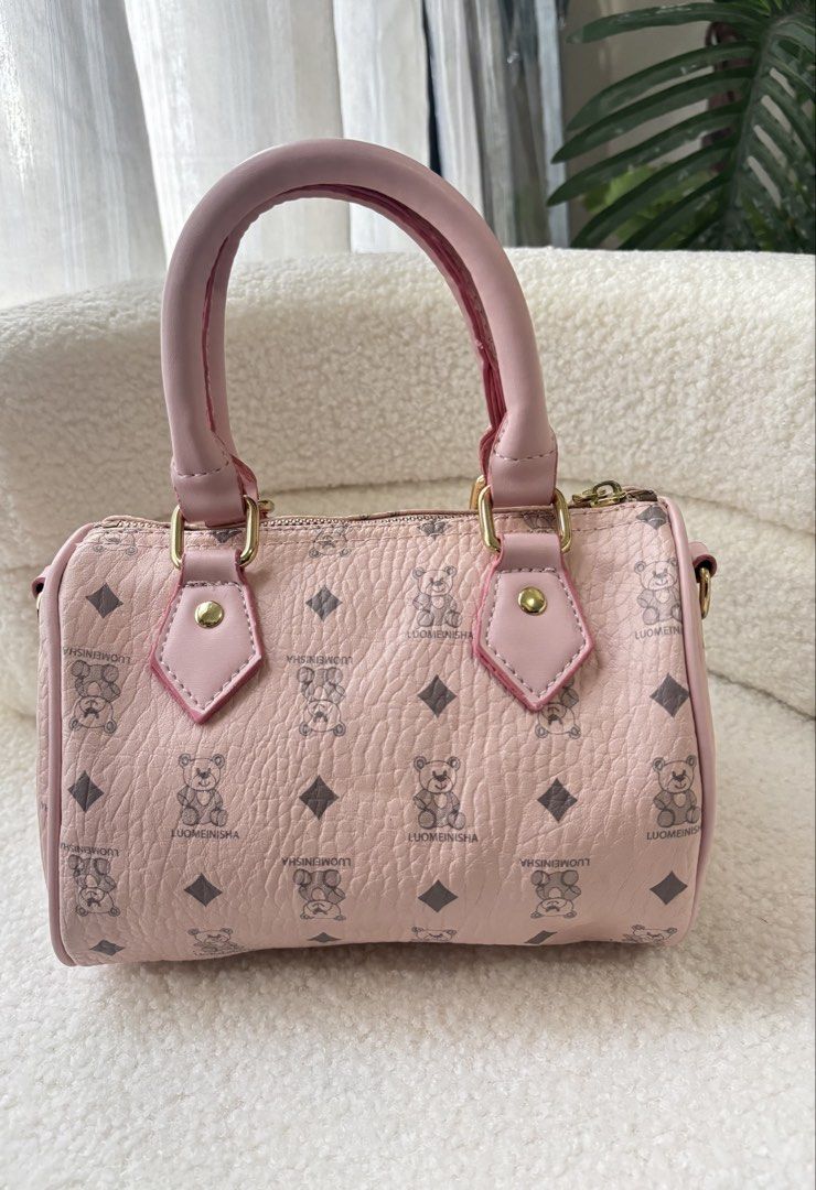 LUOMEINISHA Pink Bear Pattern Mini Barrel Handbag (Category: Shoulder Bags) located in Makati City. Submitted by bittersweet818ta (Listing ID 1467137996, Image 2). Description: - Adorable pink barrel handbag with teddy bear and diamond monogram pattern - Dual pink faux leather top handles and secure top zip closure - Includes a cute matching shaped bag charm with gold-toned hardware - Versatile design featuring a removable/detachable strap inside