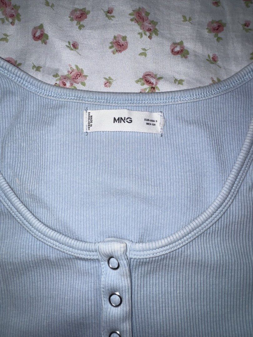 Mango Blue Ribbed Button Tank Top Size S (Category: Sleeveless) located in Medellin. Submitted by bluevelvet_tree (Listing ID 1467061199, Image 3). Description: - Brand: Mango - Size: Small - Color: Light Blue with slightly fades but it is its own design - Material: Soft, stretchy ribbed fabric - Design: Scoop neckline with a 3-button front placket - Origin: Made in Bangladesh.