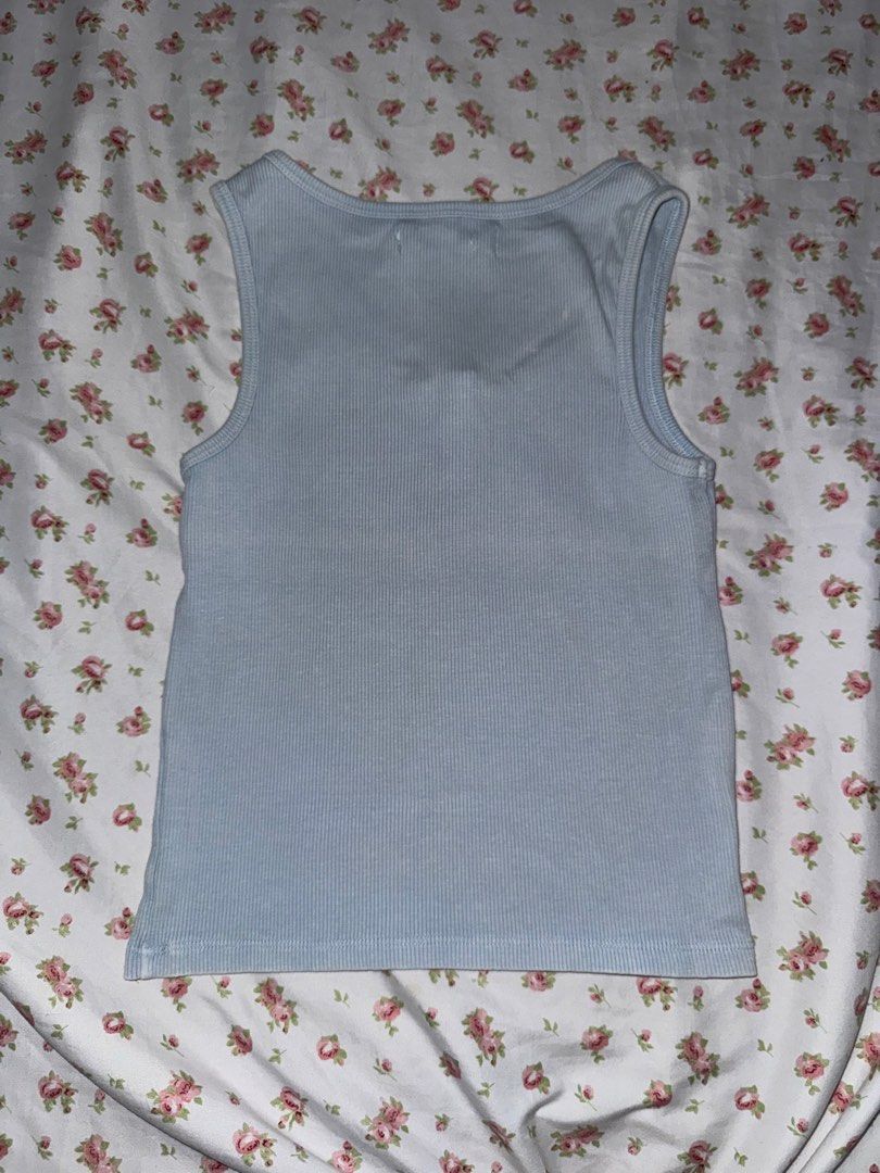 Mango Blue Ribbed Button Tank Top Size S (Category: Sleeveless) located in Medellin. Submitted by bluevelvet_tree (Listing ID 1467061199, Image 2). Description: - Brand: Mango - Size: Small - Color: Light Blue with slightly fades but it is its own design - Material: Soft, stretchy ribbed fabric - Design: Scoop neckline with a 3-button front placket - Origin: Made in Bangladesh.