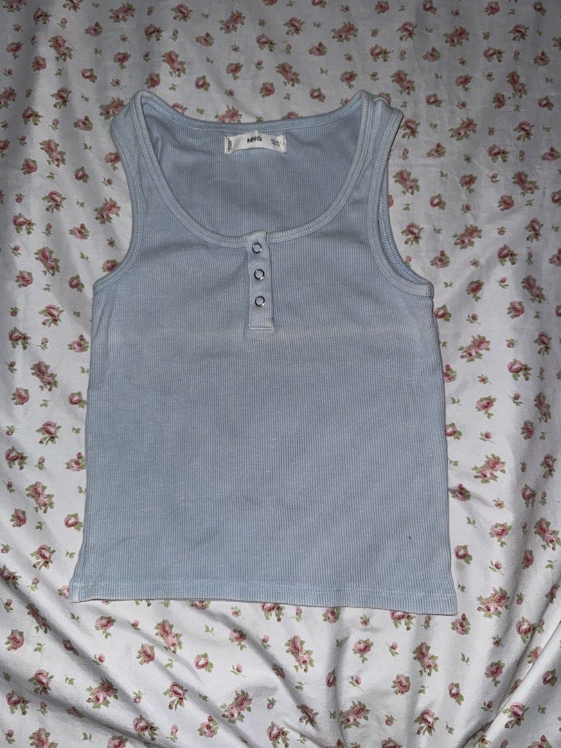 Mango Blue Ribbed Button Tank Top Size S (Category: Sleeveless) located in Medellin. Submitted by bluevelvet_tree (Listing ID 1467061199, Image 1). Description: - Brand: Mango - Size: Small - Color: Light Blue with slightly fades but it is its own design - Material: Soft, stretchy ribbed fabric - Design: Scoop neckline with a 3-button front placket - Origin: Made in Bangladesh.