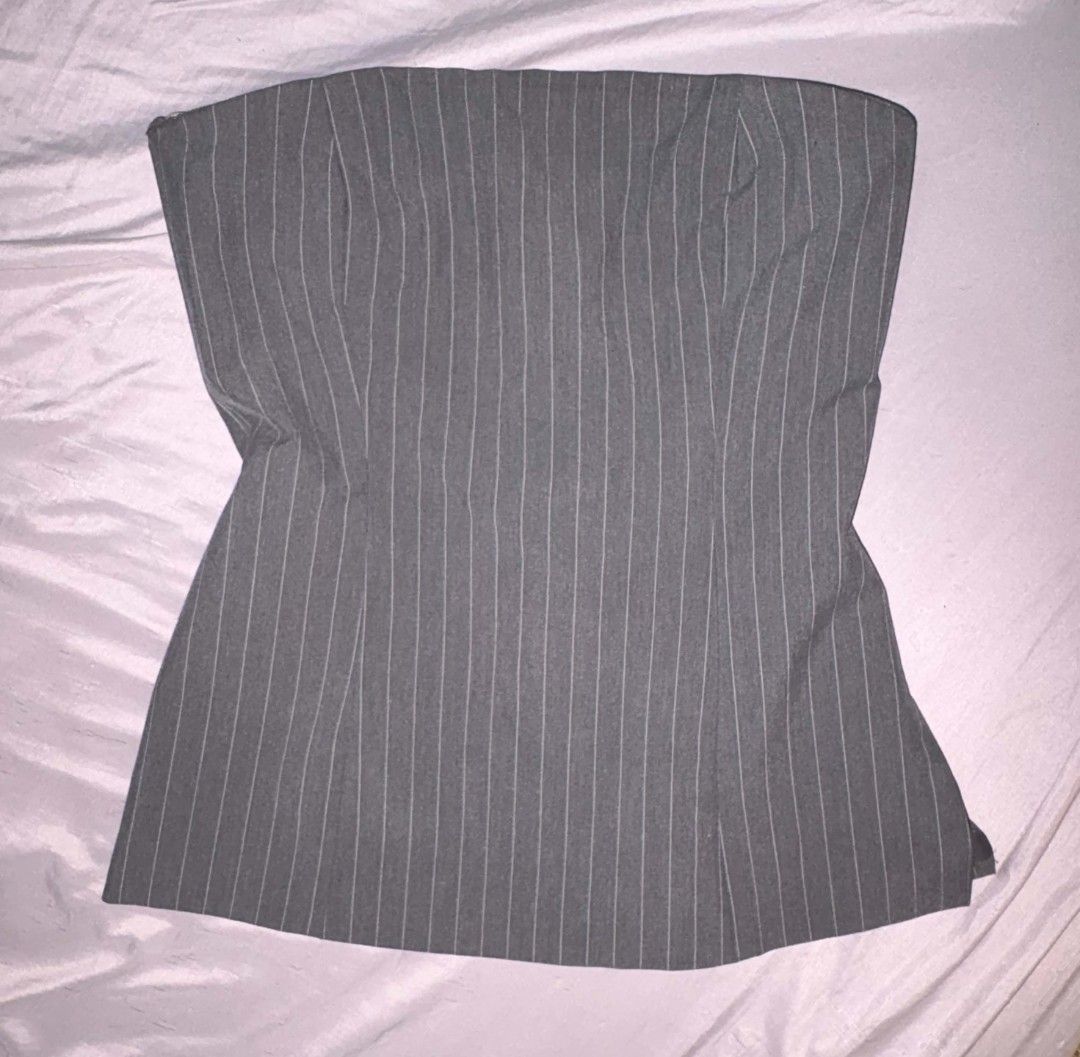 Mango tube top Pinstripe Grey (Category: Sleeveless) located in Manila. Submitted by jasja (Listing ID 1467013790, Image 2). Description: - Color & Pattern: Grey with subtle vertical pinstripes - Fit & Style: Tailored bodice with a clean, straight neckline - Material: Structured fabric that holds its shape well - Styling: Great for pairing with trousers or skirts for a sharp, polished look - Original Retail Price: ₱2,495.