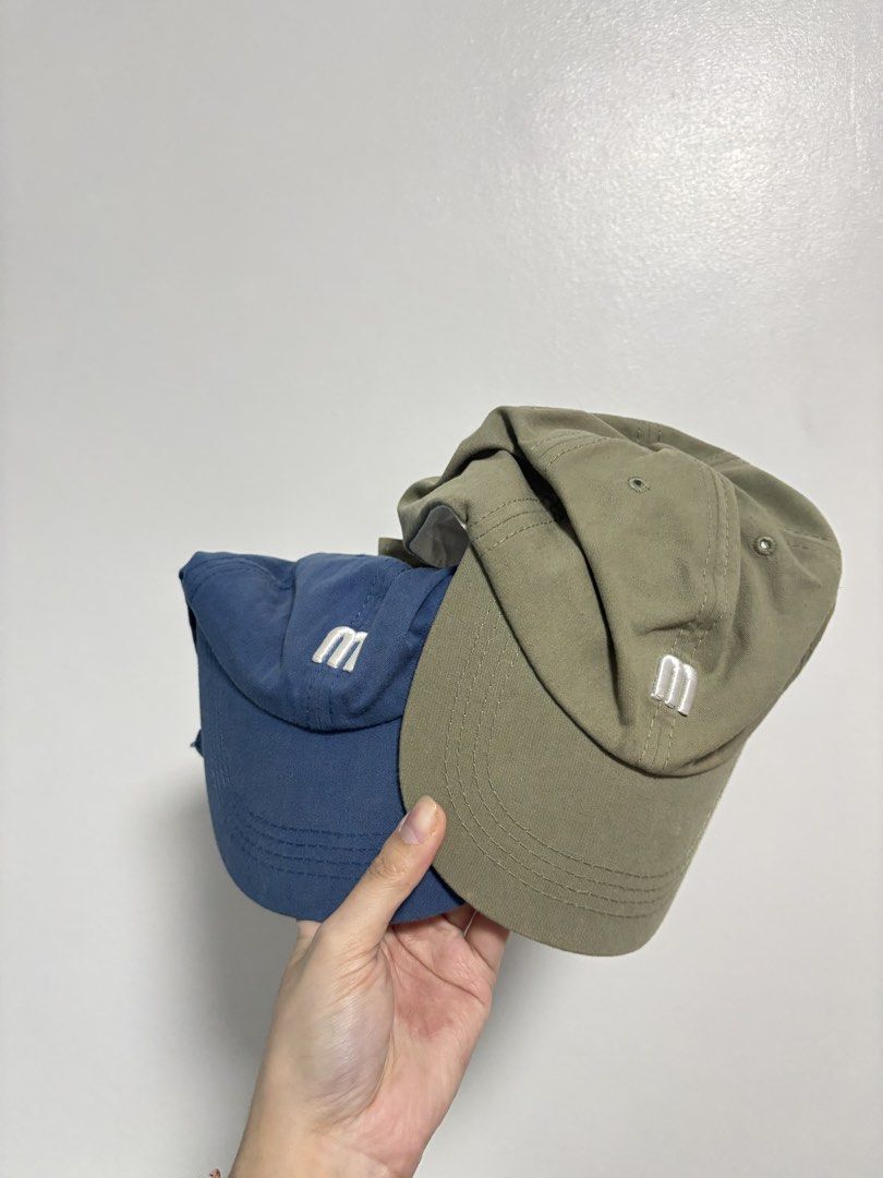 Mantou Caps Set Blue Olive Green (Category: Caps & Hats) located in Imus. Submitted by _monicakes (Listing ID 1467023720, Image 1). Description: - Brand: Mantou - Quantity: 2 caps (Bundle pair) - Colors: Blue and Olive Green - Design: Embroidered 'm' on the front panel - Fit: Adjustable strap at the back - Condition: Clean inside and out.