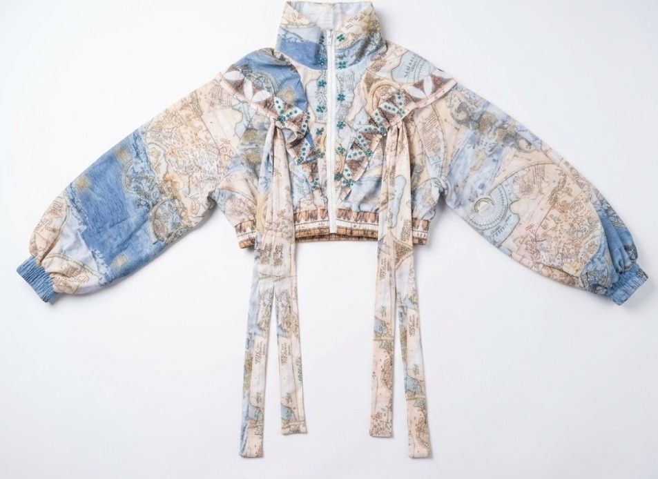 Map Print Zip-Up Crop Jacket with Beads and Ties (Category: Coats, Jackets and Outerwear) located in Donsol. Submitted by saksthriftavenuebyluckymaria8 (Listing ID 1467090531, Image 3). Description: - Unique crop jacket with a vintage map print in soft blue and beige tones - Features a high collar, zip-up front, and comfortable elastic cuffs - Decorated with eye-catching faux pearls and turquoise rhinestones along the front and shoulders - Design