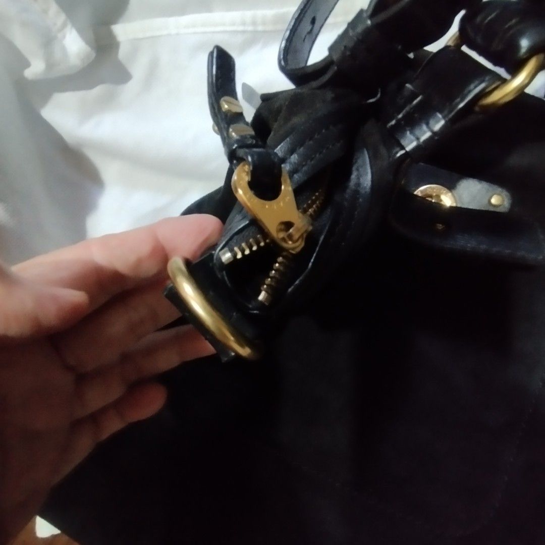 Marc by Marc Jacobs black suede handbag (Category: Cross-body Bags) located in Manila. Submitted by lene48 (Listing ID 1467032044, Image 2). Description: - Authentic Marc by Marc Jacobs black suede shoulder bag - Elegant gold-tone hardware with signature turnlock front pocket - Dual top handles and a removable long strap for versatile wear - Secure zip top closure - Spacious interior featuring black and white logo lining, zip pocket, and slip poc